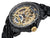 Engraved gold color dial with Roman numerals on the black bezel. An engraved circled crown.